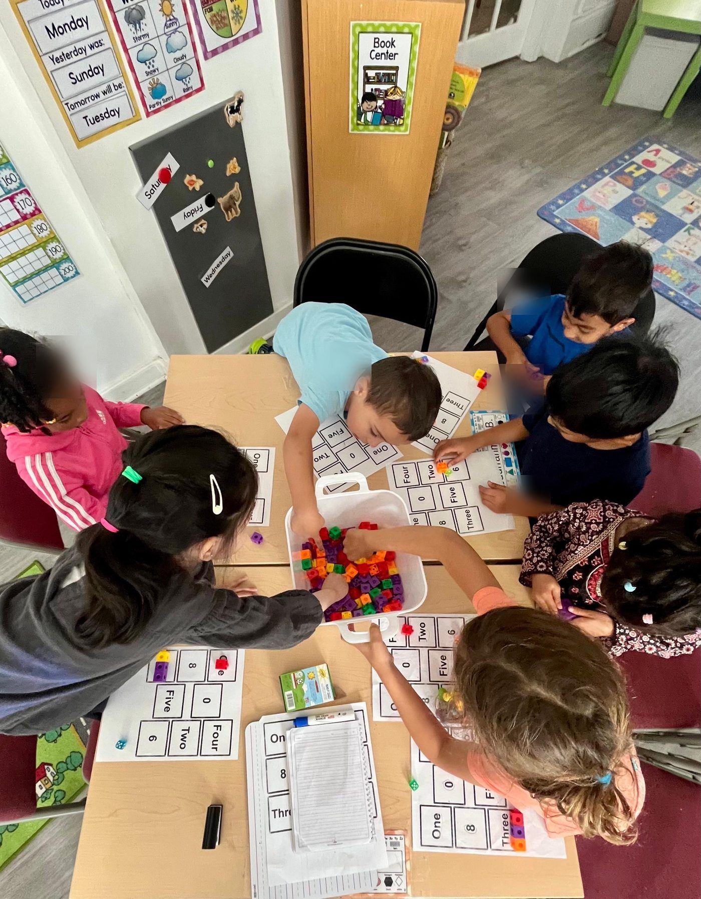 Students matching counting cubes to number boards, seen from above